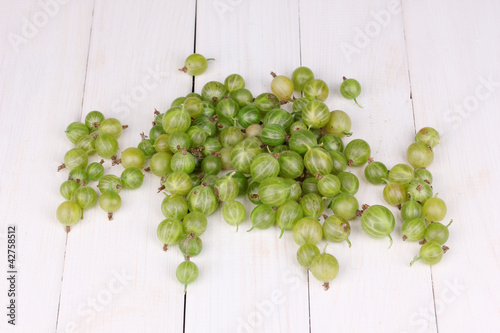 Green gooseberry on wooden background photo