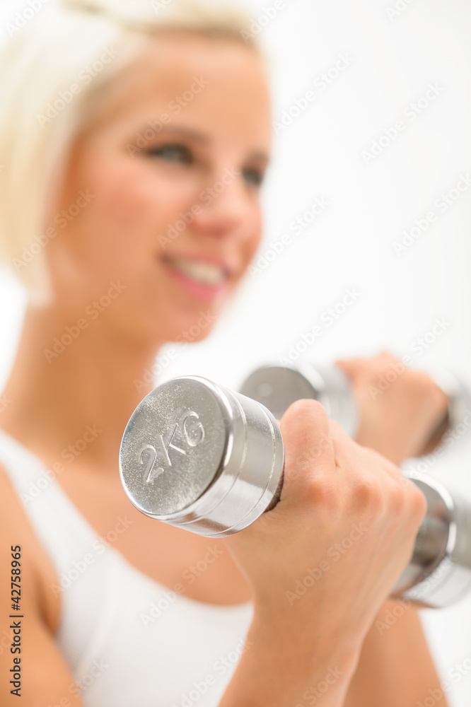 Woman exercise dumbbells white fitness close-up Woman exercise dumbbells white fitness close-up
