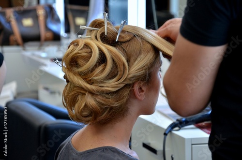 closeup of a woman making her hair done in a hair dresser salon