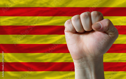 Hard fist in front of catalonia flag symbolizing power photo