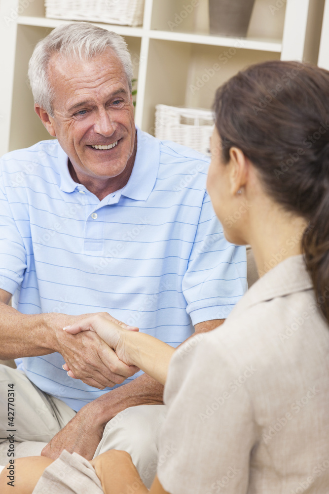 Saleswoman Shaking Hands With Senior Man at Home Saleswoman Shaking Hands With Senior Man at Home