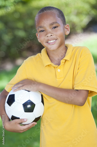 African American Boy Playing With Football or Soccer Ball