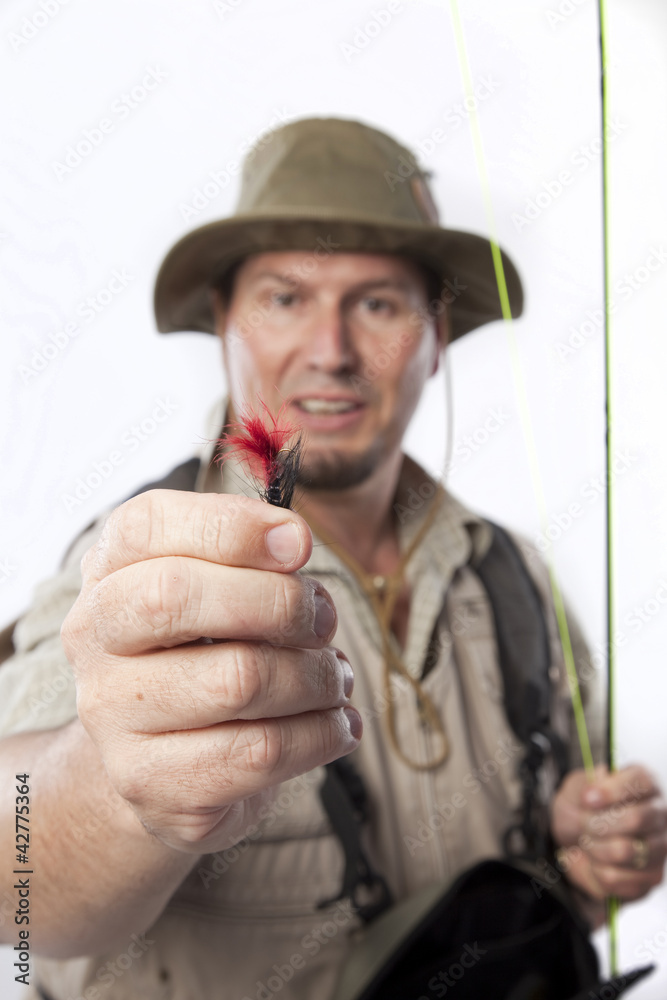 Fototapeta premium Fly fisherman holding out his favourite bait.