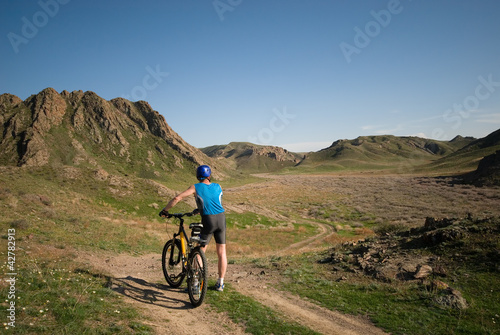 Mountain bicyclist in beautiful wild terrain