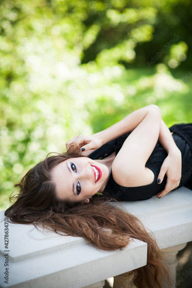 Fototapeta premium Beautiful woman lying down outdoors