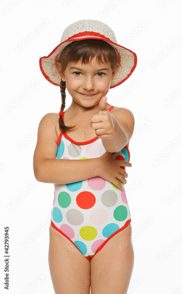 Smiling girl in swimming wear showing thumb up sign Smiling girl in swimming wear showing thumb up sign