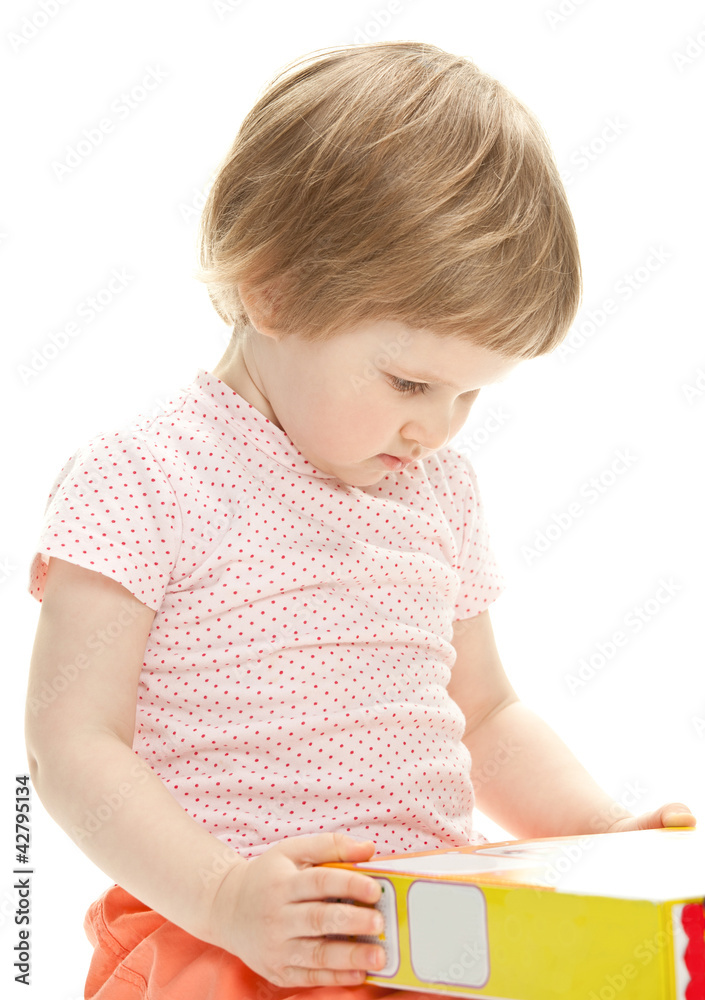 Little girl holding new toy ready to unbox it Little girl holding new toy ready to unbox it