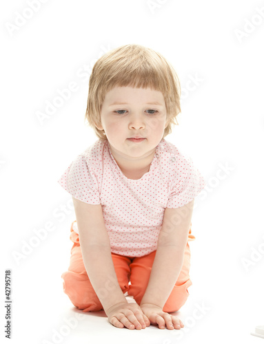 Cute little girl sitting on the floor