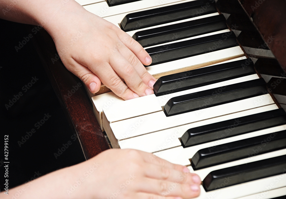 child's hands playing the piano child's hands playing the piano