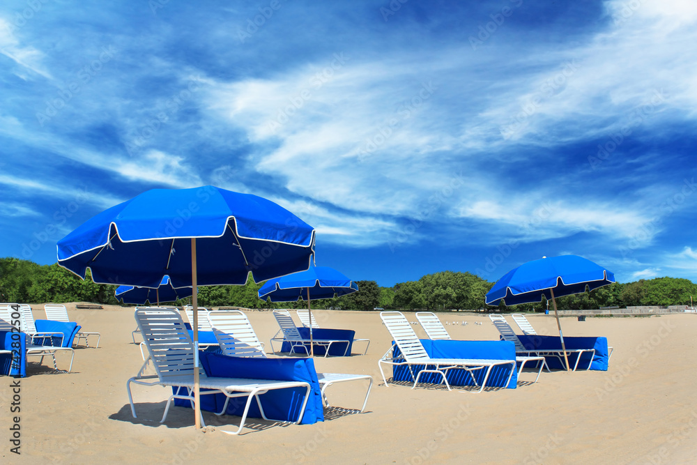 Tropical beach on a sunny day with chairs and umbrellas