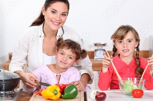 Children preparing a meal with mum