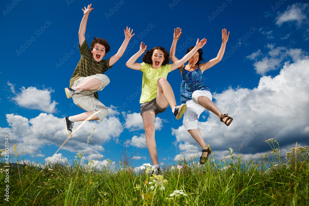Active family - mother and kids running, jumping outdoor Active family - mother and kids running, jumping outdoor