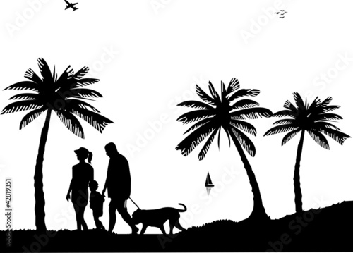 Family walking on beach with dog between the palms silhouette