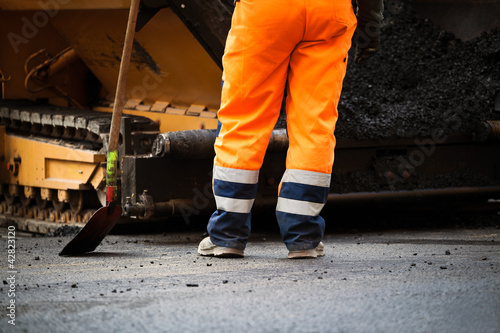 Road construction worker and shovel