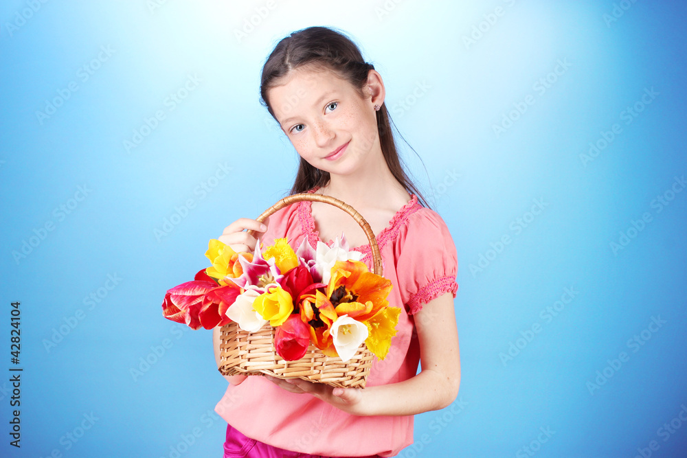Portrait of beautiful little girl with tulips in basket Portrait of beautiful little girl with tulips in basket