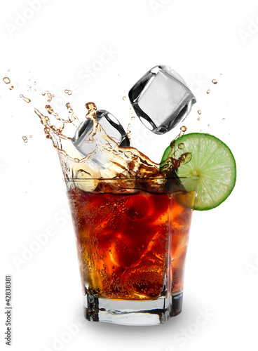 Ice cube and lime splashing cola glass, Cuba Libre drink photo