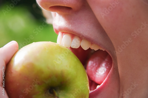 Junge Frau beißt in einen Apfel