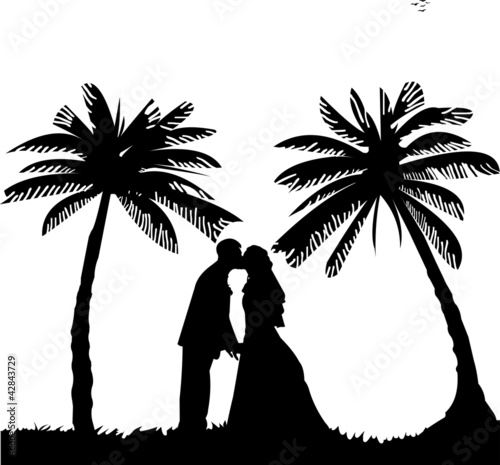 Wedding couple, groom and bride between the palms on the beach