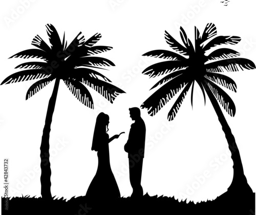 Wedding couple, groom and bride between the palms on the beach