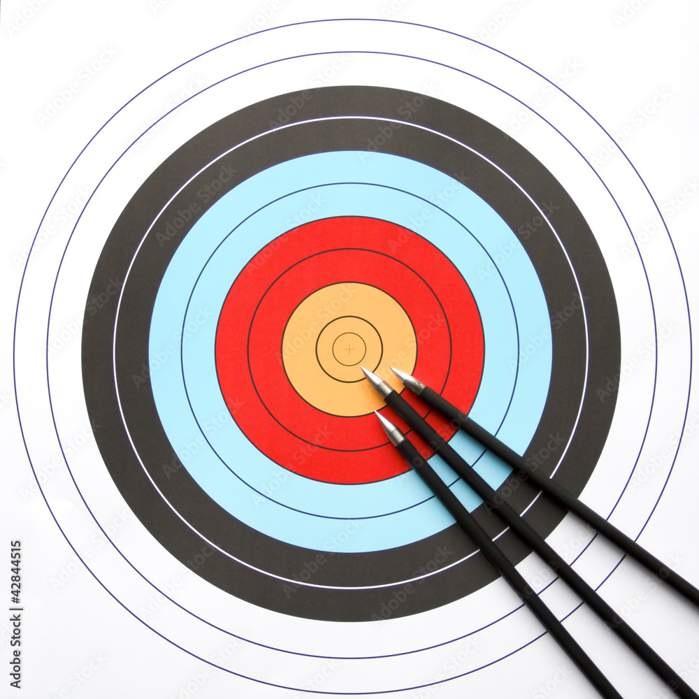 Three arrows pointing to the center of an archery target Three arrows pointing to the center of an archery target