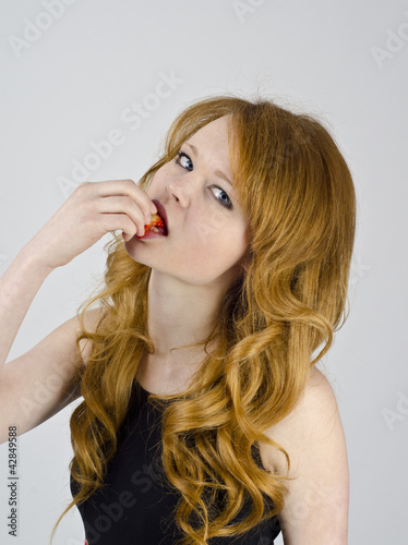 Young girl with strawberry