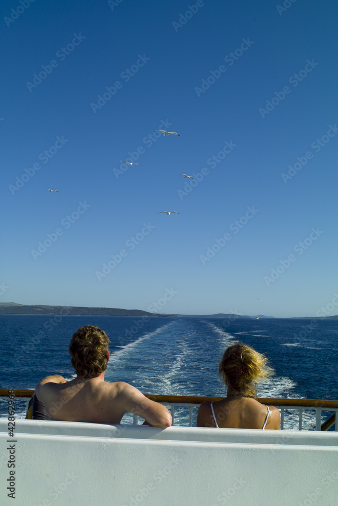 A couple looking to the open sea A couple looking to the open sea