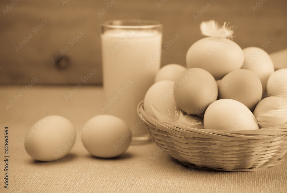 Milk and a basket of eggs. Sepia Milk and a basket of eggs. Sepia