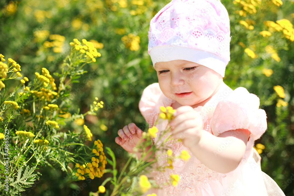 Cute child girl in yelow flower field Cute child girl in yelow flower field