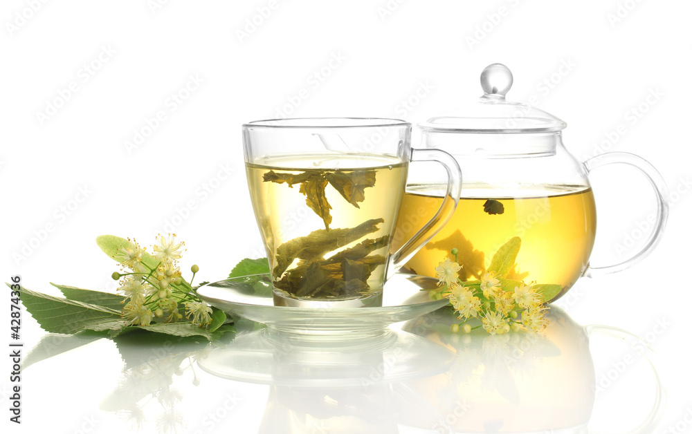 cup and teapot of linden tea and flowers isolated on white