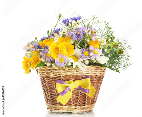 beautiful bouquet of bright  wildflowers in basket, isolated © Africa Studio