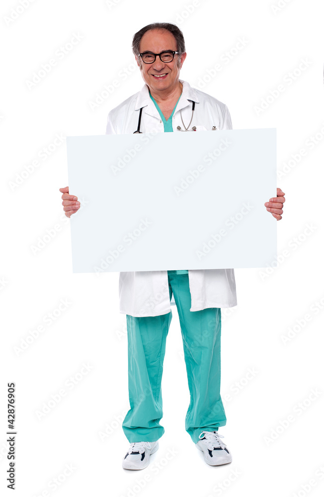 Confident doctor showing blank whiteboard Confident doctor showing blank whiteboard
