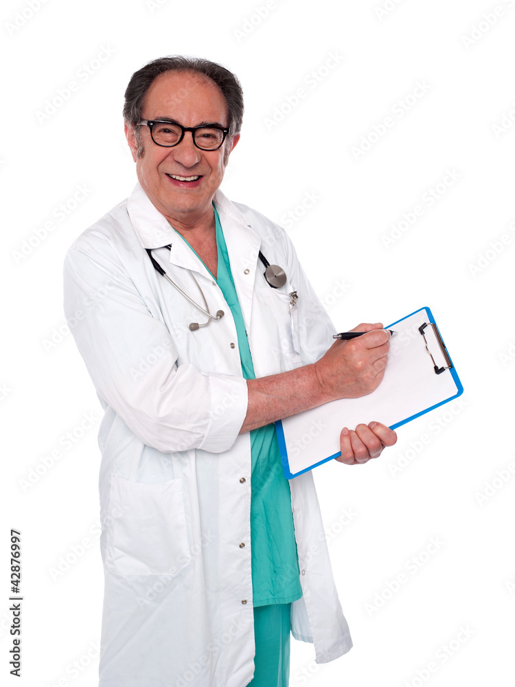 Senior surgeon writing medical report