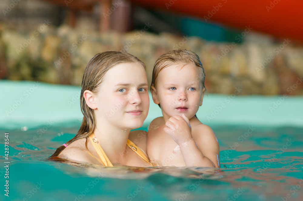 Young mother with adorable daughter swim in aqua park Young mother with adorable daughter swim in aqua park