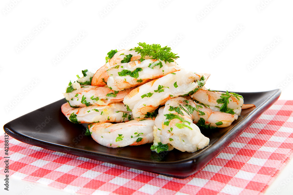 Plate with prawn snacks on checkered napkin Plate with prawn snacks on checkered napkin