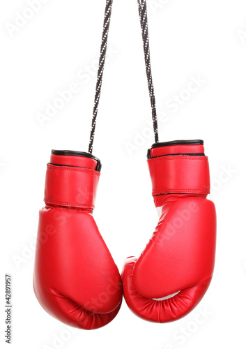 Red boxing gloves hanging isolated on white