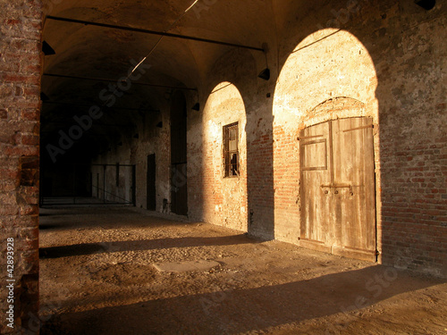 Medieval castle with arches and shadow, Melegnano, Italy photo