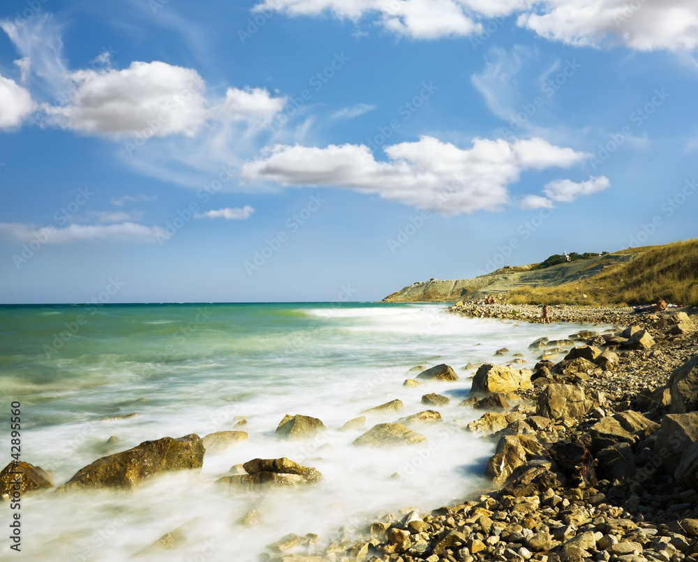 Sea Sky stones.Wave winding coastline accrue at..