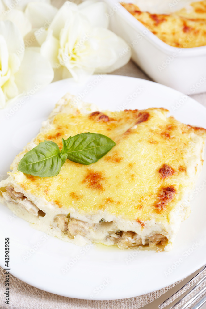 Kannelloni with chicken and mushrooms baked in sauce bechamel