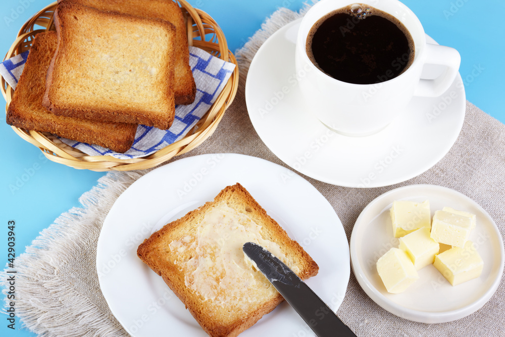 Breakfast. A cup of coffee and toasts with butter Breakfast. A cup of coffee and toasts with butter