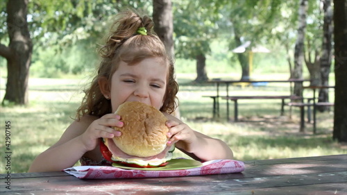 little girl eat big sandwich