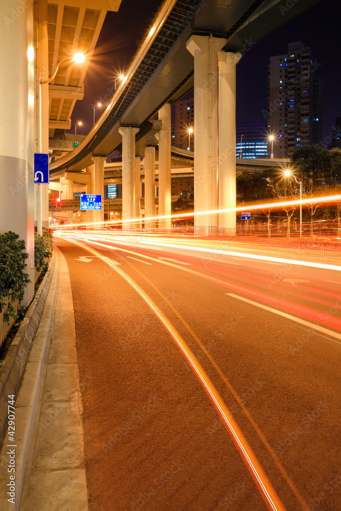 Fototapeta premium city traffic under the viaduct at night
