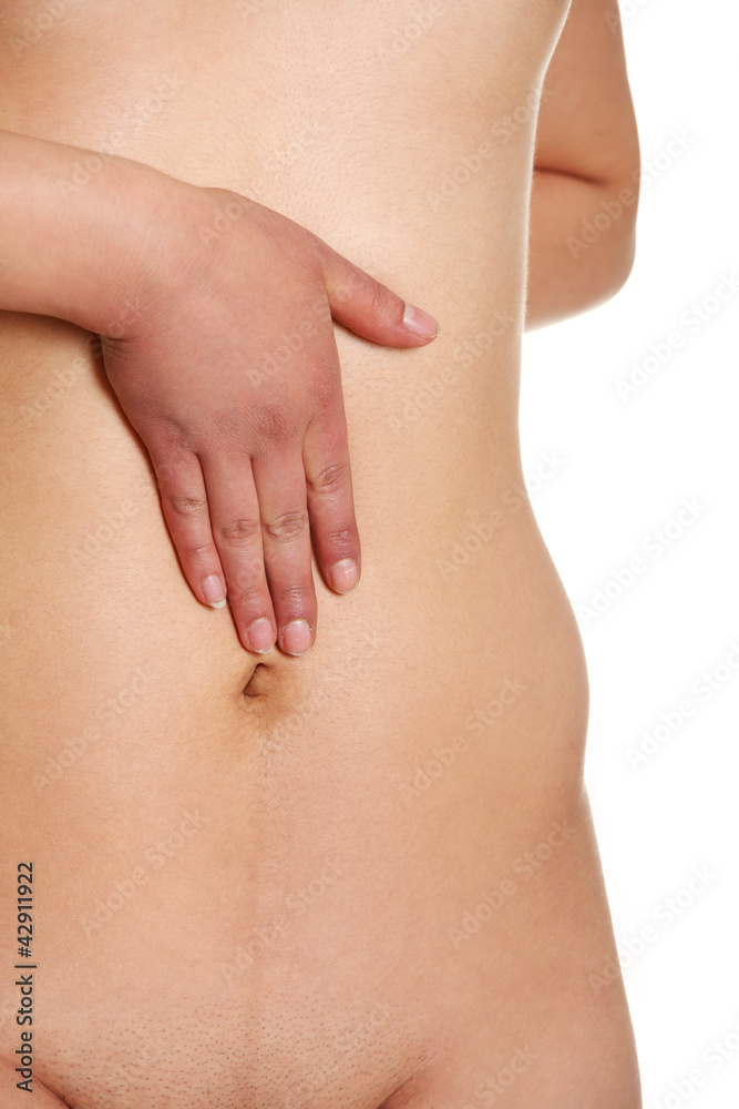 Nude woman with hand on her belly Nude woman with hand on her belly