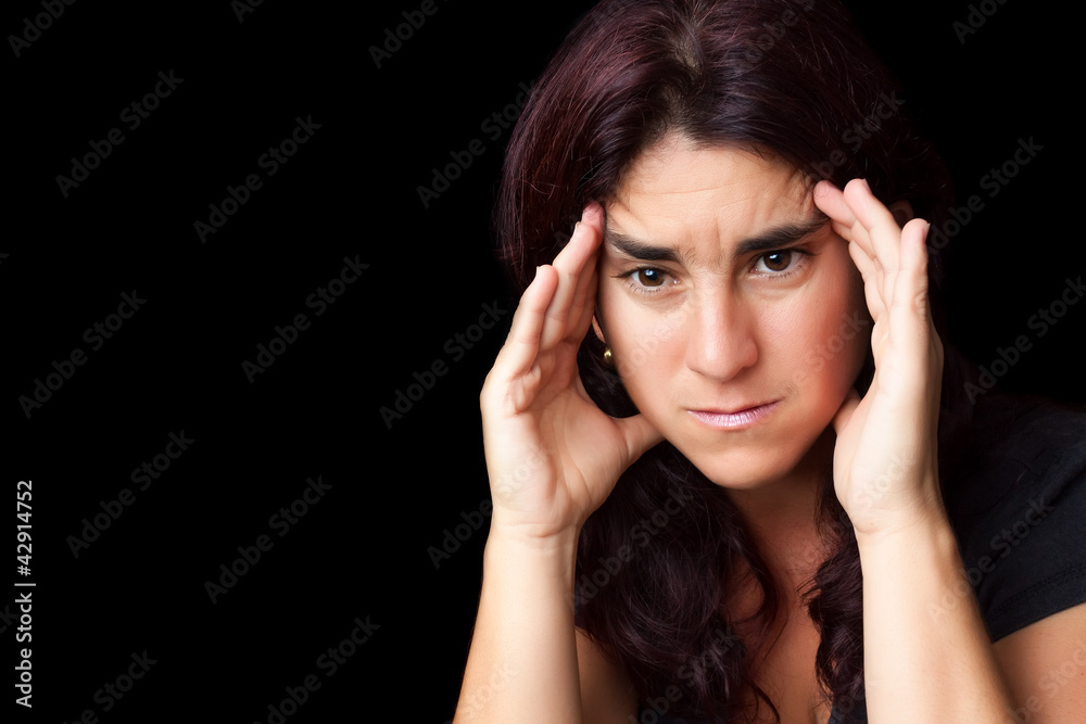 Very stressed hispanic woman isolated on black Very stressed hispanic woman isolated on black