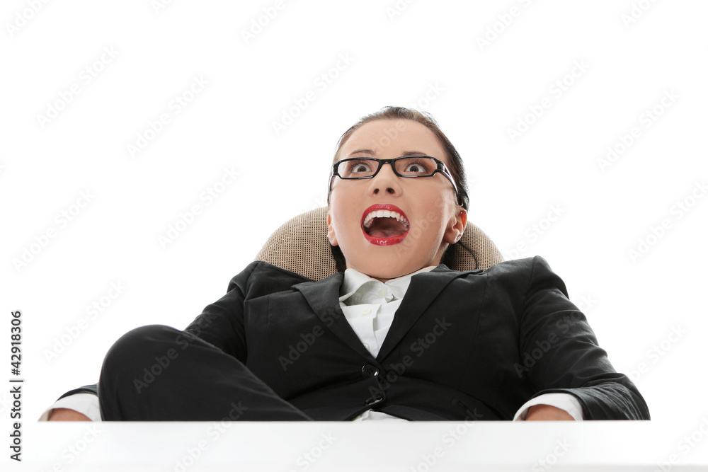 Businesswoman is sitting with surprised face.