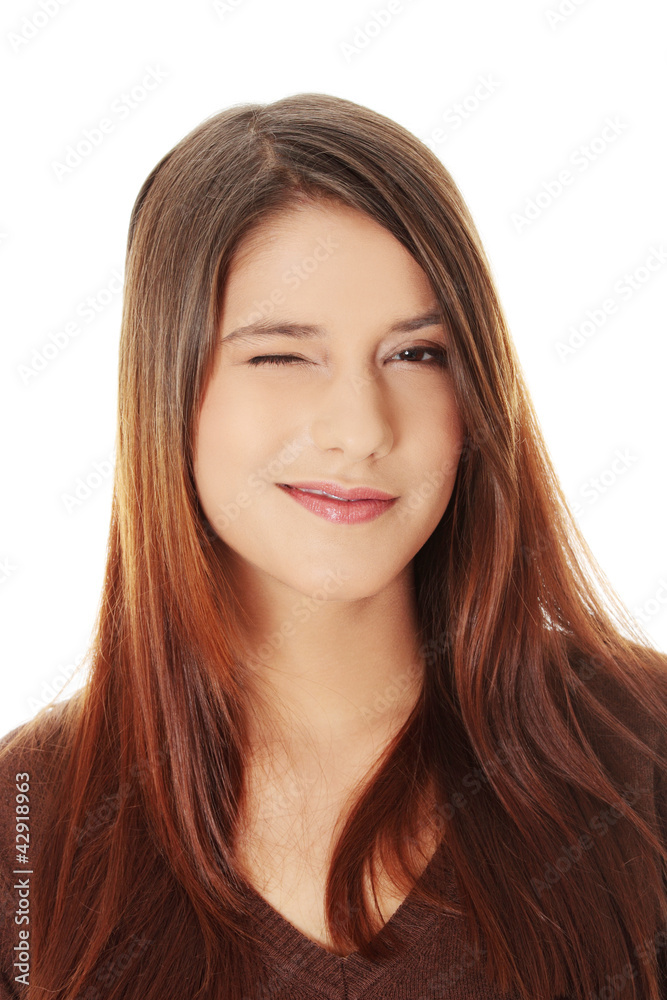 Young beautiful woman is smiling and winking. Young beautiful woman is smiling and winking.