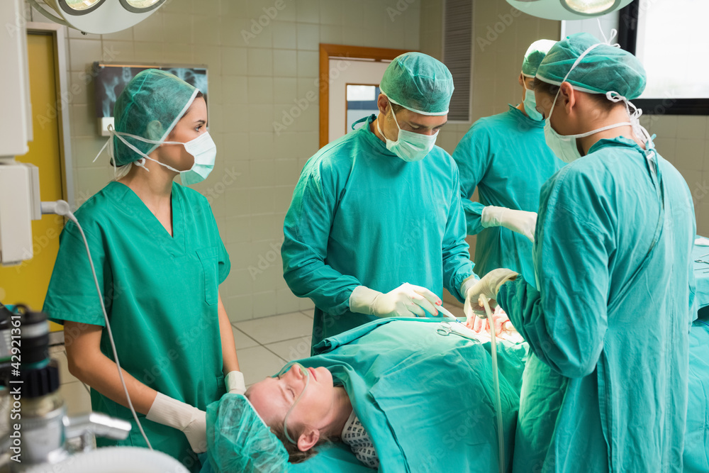 Female patient lying on a table undergoing surgery Female patient lying on a table undergoing surgery