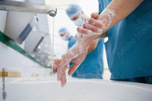 Surgeons in a hospital washing hands photo