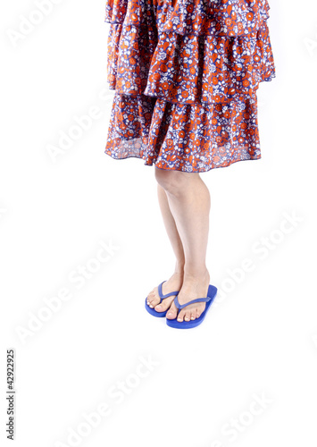 Woman Wearing Blue Flip Flops and Floral Skirt