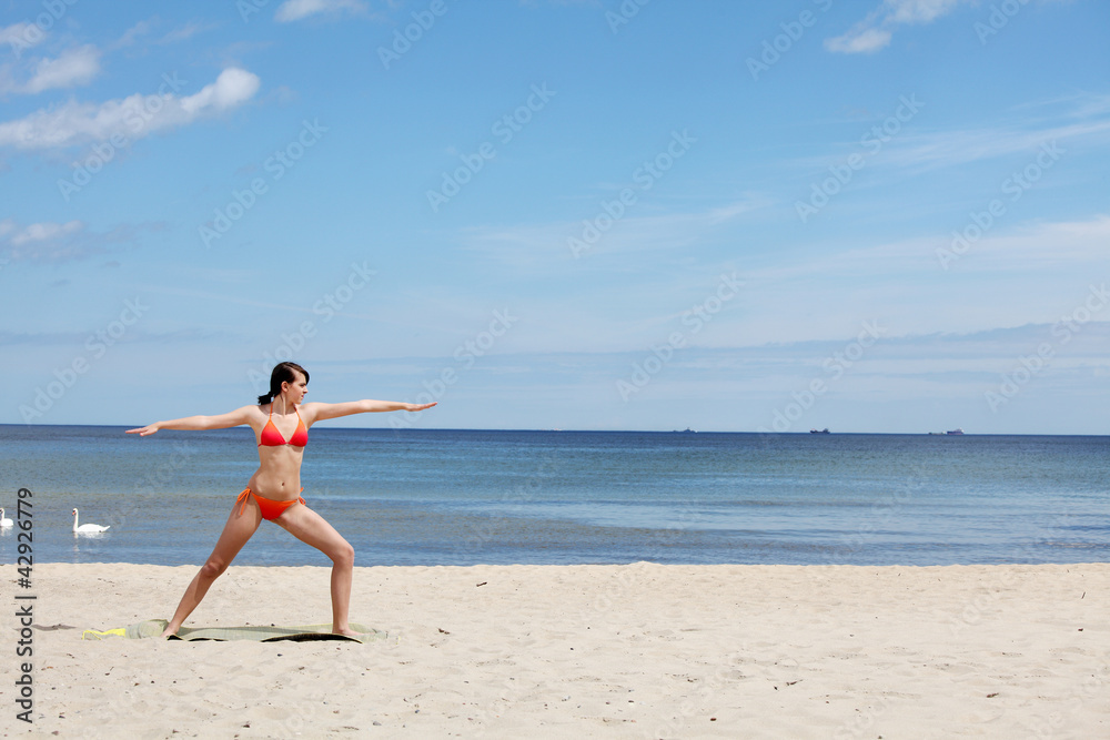 Athletic young woman is training exercises on the beach. Athletic young woman is training exercises on the beach.