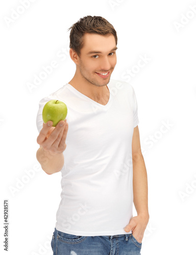 man in white shirt with green apple
